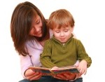 mother and three years boy reading a book isolated on white